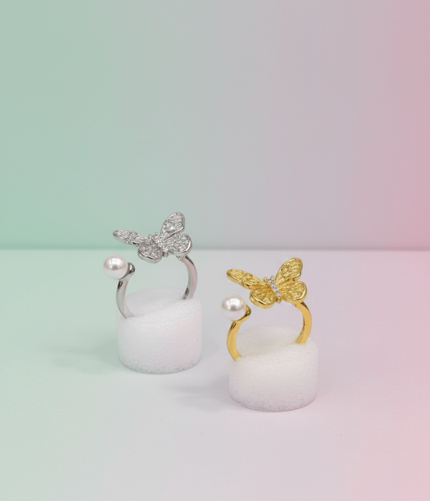 https://cdn.shopify.com/s/files/1/0777/4122/8329/files/elegant-pearl-butterfly-ring-1555568.png?v=1767746773